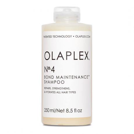 Olaplex No. 4 Bond Maintenance Shampoo bouteille transparente de shampoing blanc cassé avec étiquette blanche sur fond blanc