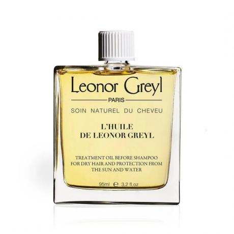 Leonor Greyl L'Huile De Leonor Greyl sebotol minyak kuning dengan tutup putih di latar belakang putih