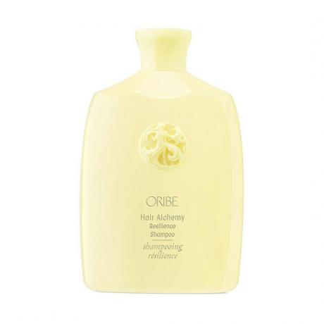 Oribe Hair Alchemy Resilience Shampoo frasco amarelo sobre fundo branco