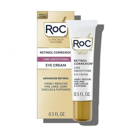 RoC Retinol Correxion Under Eye Cream: Un tub alb și auriu cu cutie de produs potrivită pe un fundal alb