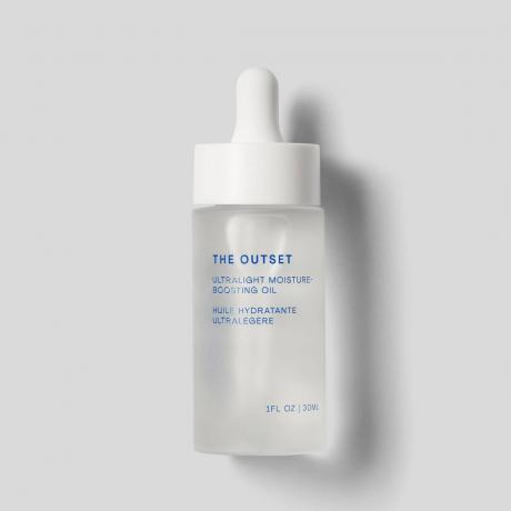 The Outset Ultralight Moisture-Boosting Oil clear serum bottle on grey background