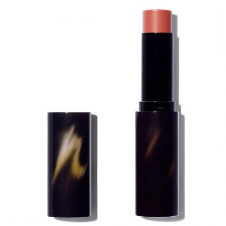 Victoria Beckham Beauty Cheeky Posh black twist up stick of terracotta blush with cap to the side on white background