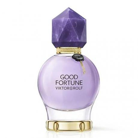 Good Fortune Eau de Parfum गोल बैंगनी बोतल सफेद पृष्ठभूमि पर बैंगनी रत्न टोपी के साथ