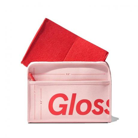 The Glossier The Beauty Bag berwarna pink dan merah dengan latar belakang putih