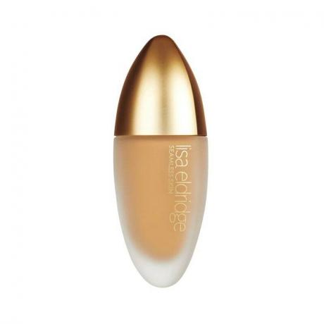 Botol alas bedak oval Lisa Eldridge Seamless Skin Foundation dengan atasan emas dengan latar belakang putih