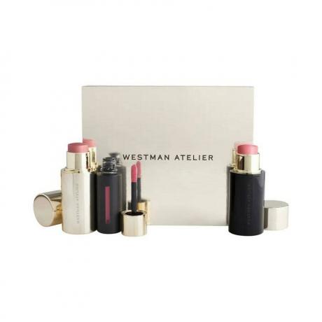Westman Atelier The Petal Edition Set bâtons de fard à joues roses et baume à lèvres liquide dans un emballage noir et or avec boîte beige sur fond blanc