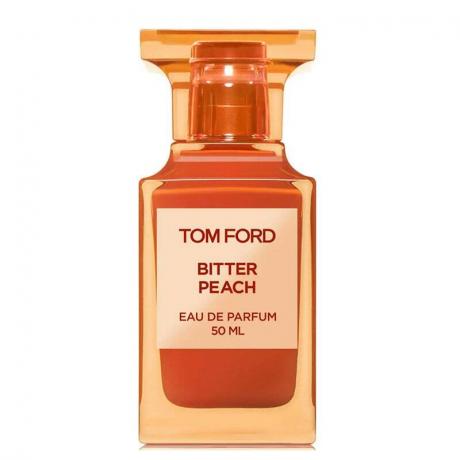 Eine orangefarbene Flasche Bitter Peach Eau de Parfum auf weißem Hintergrund