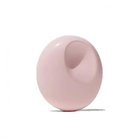 Glossier You Solid Fragrance wadah bulat merah muda dengan latar belakang putih