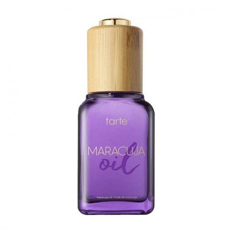 Фіолетовий флакон з олією Tarte Maracuja на білому фоні