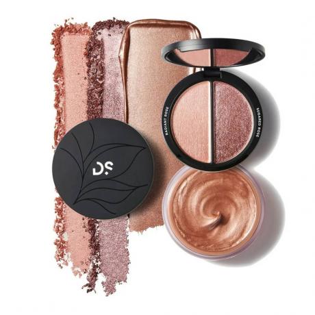Deck of Scarlet Mirror Glaze Highlighting Trio Round Compact of 2 Highlighter Shades, Jar of Liquid Bronze Highlight, Round Black Lid, and Strips Swatches on White Background.