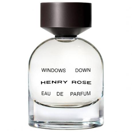 Henry Rose Windows Down Eau de Parfum caurspīdīga smaržu pudele ar melnu vāciņu uz balta fona