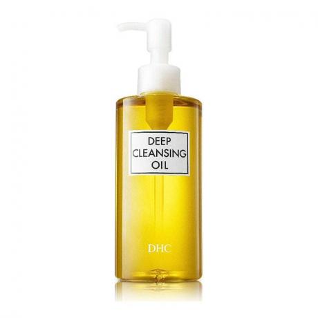 DHC Deep Cleansing Oil: Een heldere pompfles gevuld met goudkleurige gezichtsreinigingsolie op een witte achtergrond