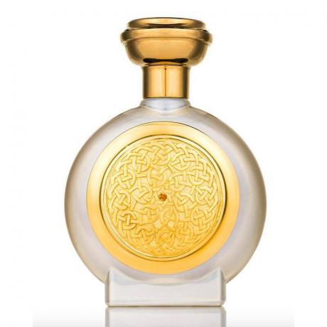 En parfymflaska i guld och klart frostat glas av Boadicea the Victorious Amber Sapphire Gold Collection Parfym på vit bakgrund