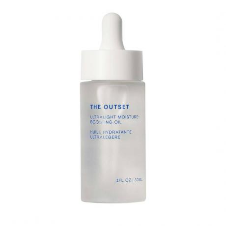 The Outset Ultralight Moisture-Boosture Botanical Oil frasco de soro transparente turvo com tampa conta-gotas branca em fundo branco
