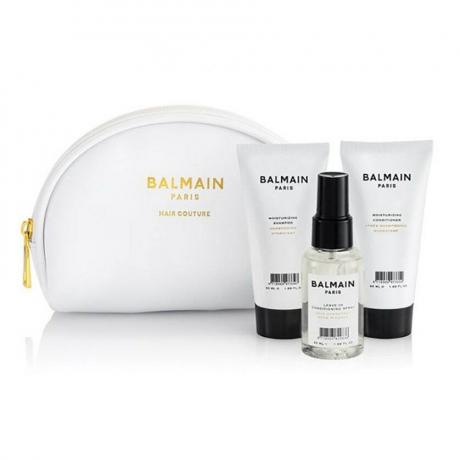 Balmain Paris Hair Couture kozmetička torba za njegu putne kolekcije bijela kozmetička poleđina i tri mini proizvoda za kosu na bijeloj pozadini
