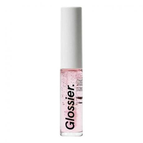Glossier Lip Gloss флакон със светлорозов прозрачен гланц за устни с бяла капачка на бял фон