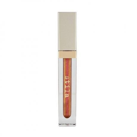 Stila Beauty Boss lūpu spīdums in Elevator Pitch caurspīdīga dzirkstoši oranža bronzas lūpu spīduma caurule ar kvadrātveida zelta vāciņu uz balta fona