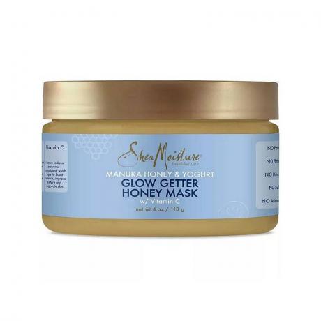 Shea Moisture Manuka Honey and Yogurt Glow Getter Honey Mask zlato obarvan kozarec z modro etiketo na belem ozadju